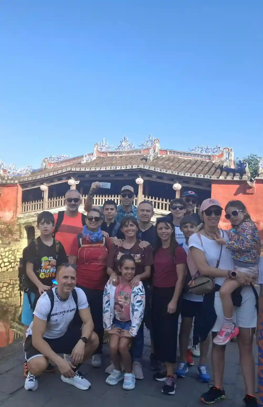 Travellers with a local guide at the Japanese Covered Bridge, Hoi An