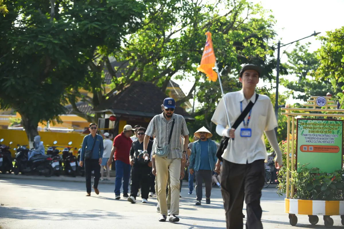 Local guide leading a small group on a free walking tour through Hoi An Ancient Town.